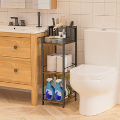 a bathroom with a toilet, sink and shelving unit