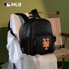 Made of synthetic leather NY logo is prominently embroidered on the front pocket. Top zipper closure Includes a spacious main compartment and a front zippered pocket for easy access to essentials. Side pockets provide additional storage options A zippered pocket on the back Adjustable padded shoulder straps 13.2"(L) x 6.5"(W) x 13"(H) Interior Capacity: Large Black College Bag For Back To School, Back To School College Bags With Zipper Closure, Black Logo Bags For Outdoor Activities, Back To School Black College Bag, College Bags With Zipper Closure For Back To School, Sporty Leather Backpack, Black College Backpack, Casual Backpack With Embroidered Logo, Sporty College Backpack