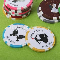 four different colored poker chips sitting on top of a green table