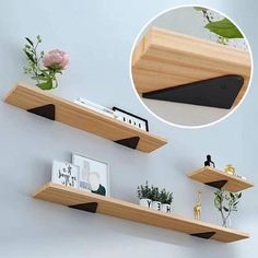 two wooden shelves with plants and pictures on them