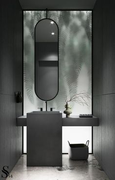 a bathroom with a mirror, sink and plant on the counter top in front of it