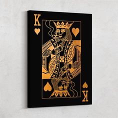 a gold and black ace playing card on a white wall