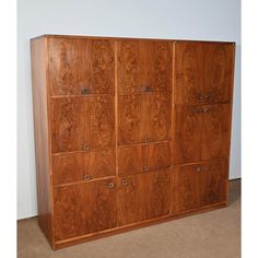 a large wooden cabinet with many drawers on it's sides and two doors at the top