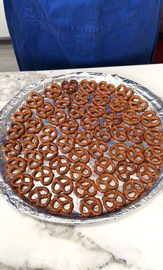 there is a platter full of pretzels on the kitchen counter, ready to be eaten