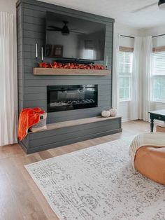 a living room with a couch, chair and fireplace in it's centerpiece