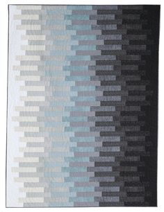 a black and white quilt with blue, gray and grey squares on the bottom half