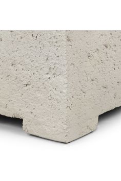 a concrete block is shown with the corner cut out to show it's texture