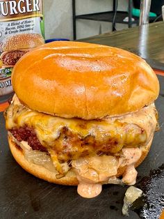 a sandwich sitting on top of a table next to a bag of burger