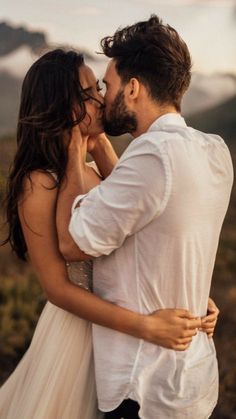 a bride and groom kissing in the mountains at their wedding day photo by wild connections photography