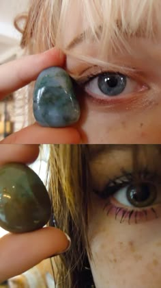 a woman holding two rocks in front of her face and the other one with blue eyes