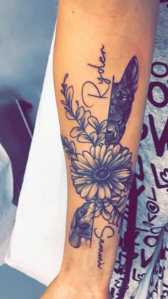 a person with a tattoo on their arm holding a flower and a dog's head