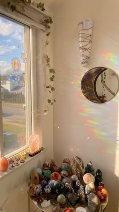 there are many different items in the corner of this room, including vases and glassware