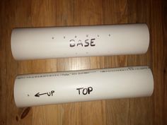 two baseball bats with the words base and top written on them sitting on a wooden surface