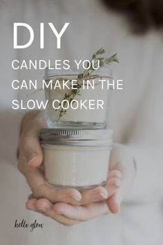 a woman holding a jar filled with flowers and text that reads diy candles you can make in the slow cooker