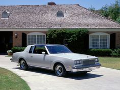 a silver car parked in front of a house