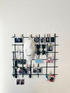 there is a wall with pictures on it and a white mask mounted to the wall