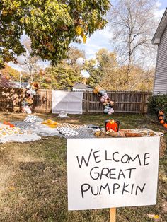 a welcome great pumpkin sign in front of a house with balloons and decorations on the lawn