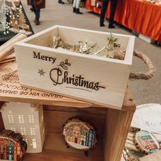 a wooden box filled with christmas ornaments on top of a table next to other decorations