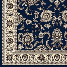 a blue and white rug with an ornate design on the bottom, surrounded by flowers