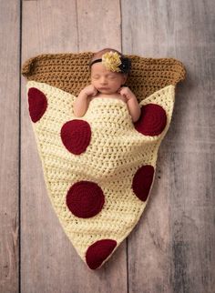 a baby is laying in a crocheted blanket