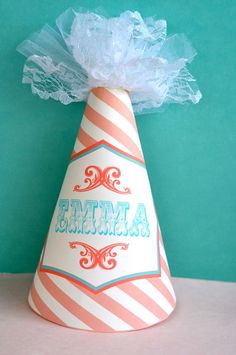 a paper party hat with the word mimia on it's side and a bow at the top