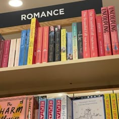 there are many books on the shelves in this library, and one is reading romance