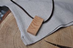 This minimalistic pendant is made out of flame pear wood, which is a very rare and extraordianary type of wood. Its unusual apperance is caused by a genetic defect or like in this case, by great pressure concentrated in one area while the tree was growing. This type of wood is a very luxury material and it is used in musical instruments industry or for creating expenisive furniture.   -------------------------------------------------------- This piece of wood was carefully polished until archiving high end smoothness and then coated with two layers of osmo 3041 oil-wax to achieve natural matt  and extra durability.  The strap was cut out of solid piece of the highest quality full-grain, leather and then dyed with chocolate brown febing's pro dye paint and coated with palc leather wax for b Minimalistic Pendant, Wood Necklace Pendant, Pear Wood, Type Of Wood, Wooden Necklace, Wood Necklace, Wooden Pendant, Wood Pendant, Handmade Wooden