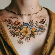 a woman wearing a necklace with flowers and butterflies painted on it's chest area