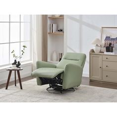 a green recliner chair sitting on top of a rug in front of a window