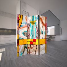 a room divider made out of stained glass with stairs in the backround