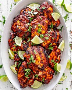 chicken with limes and cilantro in a white bowl