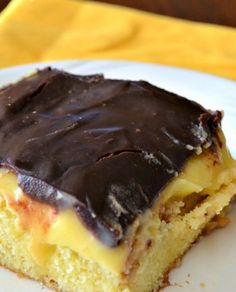 a piece of cake sitting on top of a white plate covered in chocolate frosting