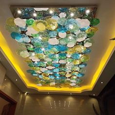 the ceiling is decorated with glass plates and lights