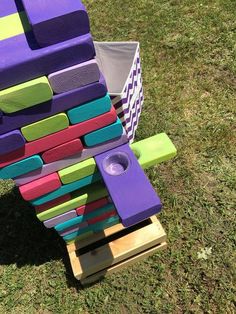 a toy made out of wooden blocks in the grass