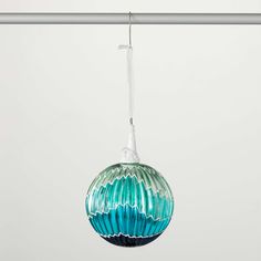 a glass ornament hanging from a metal bar