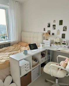 a white desk and chair in a small room