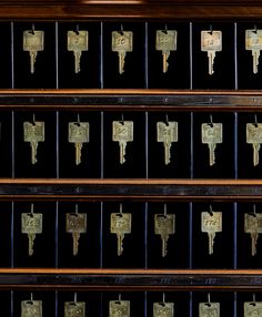 an old wooden shelf filled with lots of keys