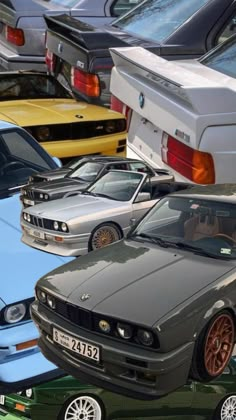 a group of cars parked next to each other on top of a parking lot filled with lots of different colored cars