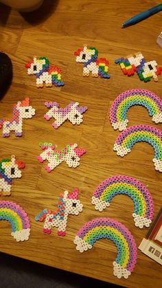 a wooden table topped with lots of different types of bead designs on top of it