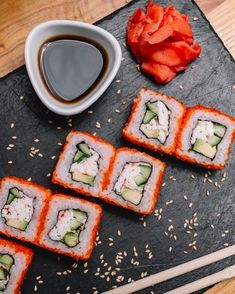 four sushi rolls with cucumber and cheese on them next to a cup of coffee