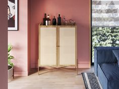 a living room with a blue couch and pink walls on the wall is a wine cabinet