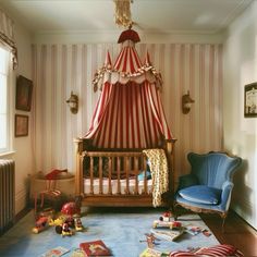 a baby's room with a canopy bed, blue chair and books on the floor