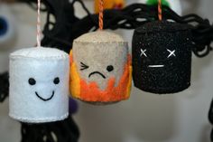 three felt halloween decorations hanging from strings