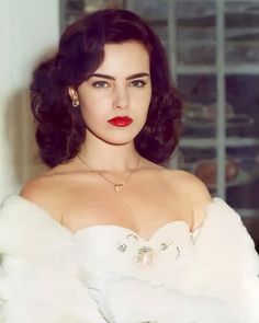 a woman wearing a white dress and red lipstick