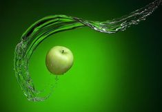 an apple is falling into the water