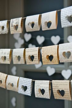 several pieces of paper with hearts hanging from them