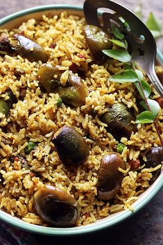 a bowl filled with rice and vegetables on top of a table