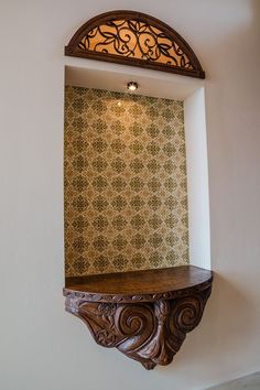 an ornate wooden shelf in the corner of a room