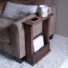 a coffee table with a cell phone on it next to a chair and rugs