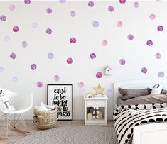 a bedroom with pink and purple polka dots on the wall